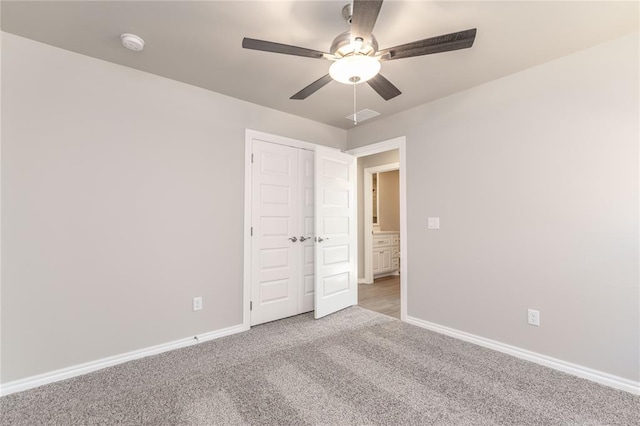 unfurnished room with ceiling fan and light colored carpet