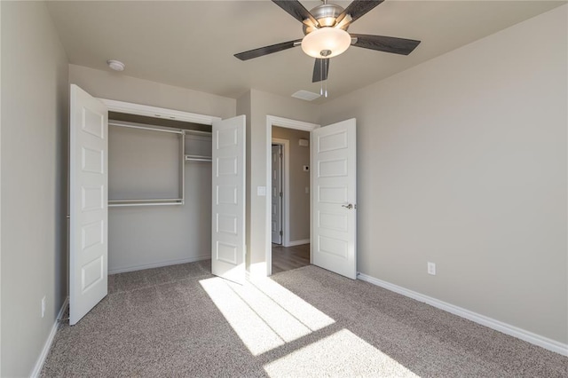 unfurnished bedroom featuring carpet, ceiling fan, and a closet