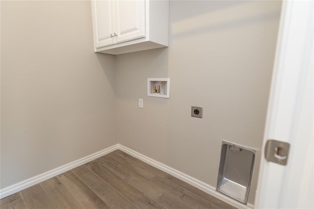 laundry area with hardwood / wood-style flooring, hookup for a washing machine, cabinets, and hookup for an electric dryer