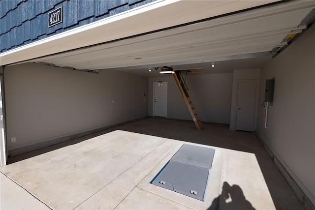 garage featuring electric panel and a garage door opener