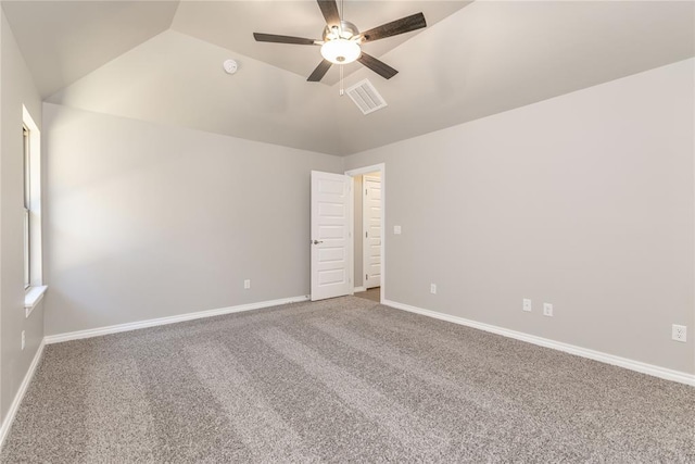 carpeted spare room featuring ceiling fan and lofted ceiling