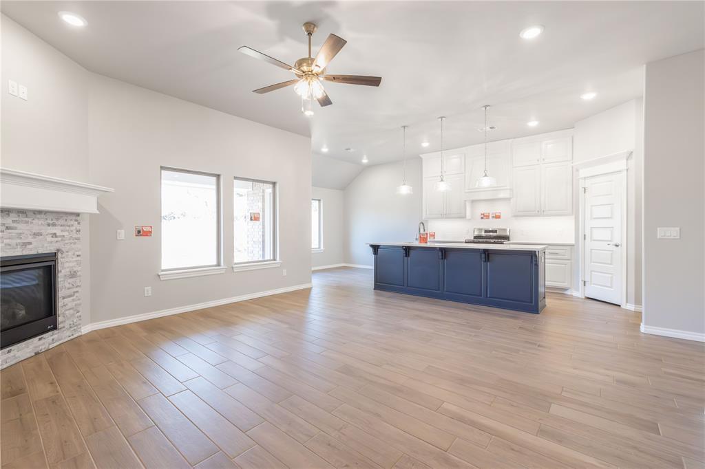 4217 Ritter Rd, Edmond, OK 73012 - kitchen featuring blue cabinets, a ceiling fan, open floor plan, white cabinets, and light countertops