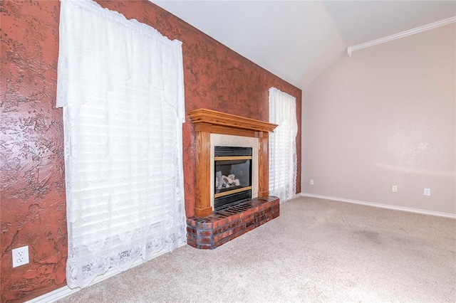 unfurnished living room featuring crown molding, a fireplace, carpet floors, and vaulted ceiling