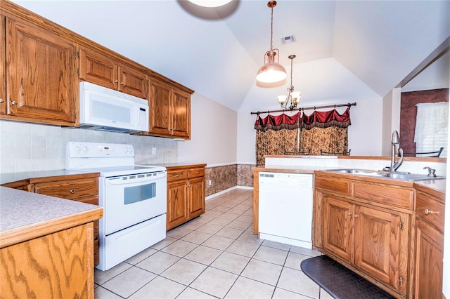 kitchen featuring sink, hanging light fixtures, lofted ceiling, white appliances, and light tile patterned flooring