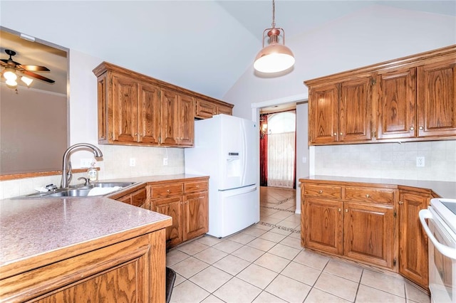 kitchen with sink, backsplash, decorative light fixtures, white appliances, and light tile patterned floors