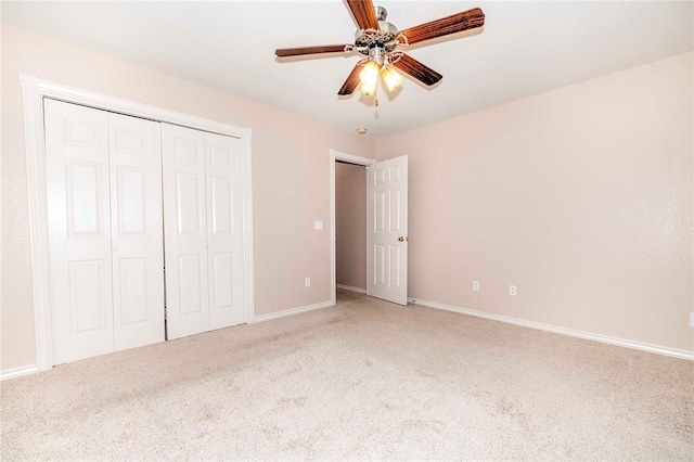 unfurnished bedroom featuring carpet, ceiling fan, and a closet