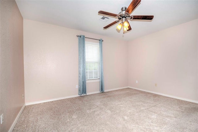 carpeted spare room featuring ceiling fan