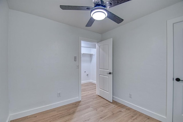 spare room featuring light hardwood / wood-style flooring and ceiling fan