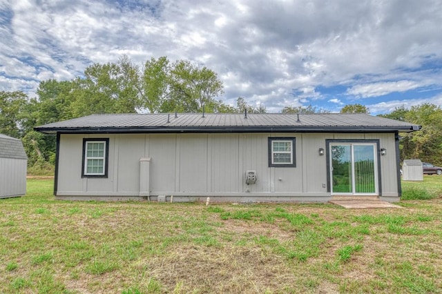 rear view of property with a lawn