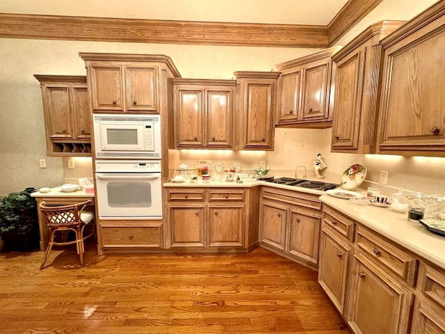 kitchen with light wood-type flooring and white appliances