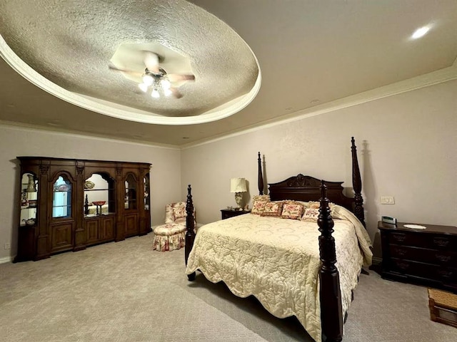 carpeted bedroom with a textured ceiling, a tray ceiling, and ceiling fan