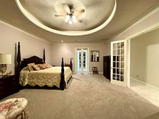 bedroom with ceiling fan, french doors, crown molding, a textured ceiling, and a tray ceiling