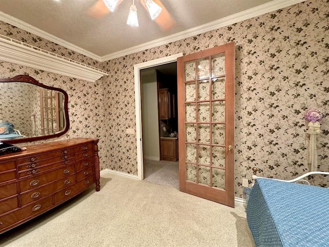 bedroom featuring crown molding, ceiling fan, light carpet, and a textured ceiling