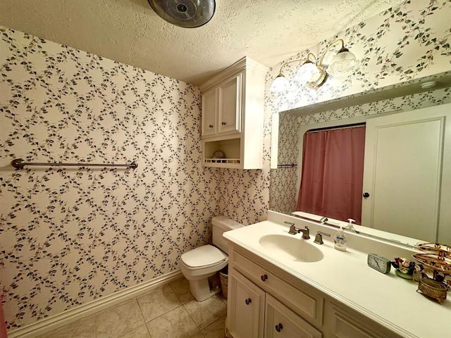 bathroom featuring tile patterned flooring, vanity, a textured ceiling, and toilet