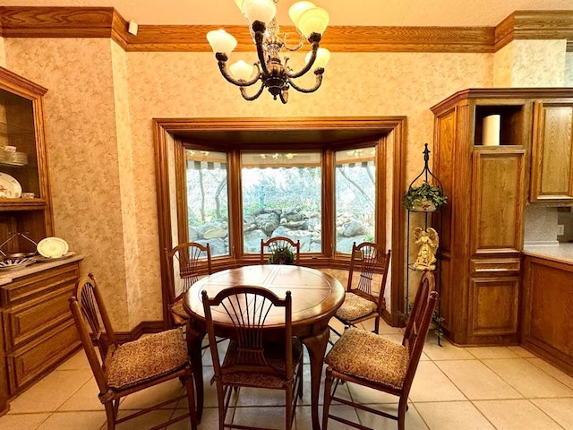 tiled dining space featuring ornamental molding and a chandelier