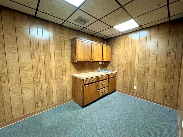 bar with wood walls and a drop ceiling