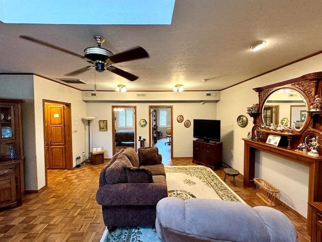 living room with ceiling fan, crown molding, parquet floors, and a textured ceiling