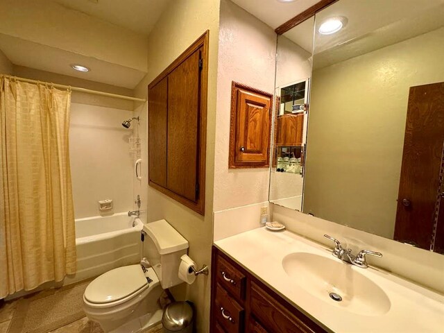 full bathroom featuring vanity, shower / tub combo, and toilet