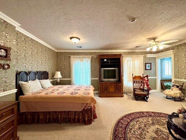 carpeted bedroom featuring a textured ceiling, ceiling fan, and crown molding