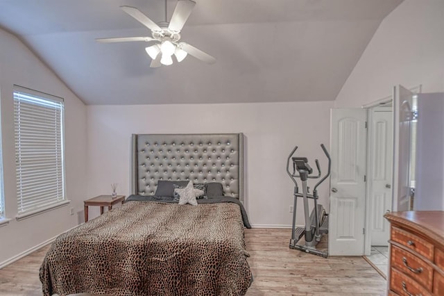 bedroom with lofted ceiling, light hardwood / wood-style flooring, and ceiling fan