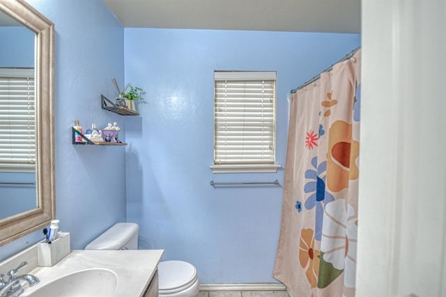 bathroom with vanity, toilet, and walk in shower