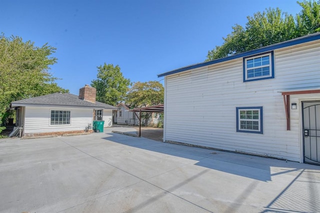 view of side of property with a patio and a carport