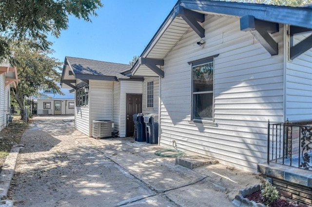 rear view of house with central AC unit