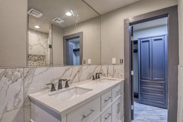 bathroom with vanity and tile walls