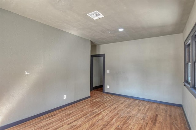 spare room with wood-type flooring