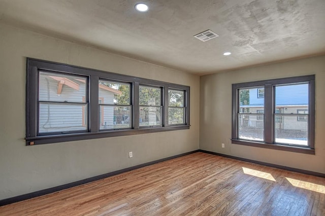 unfurnished room featuring hardwood / wood-style flooring