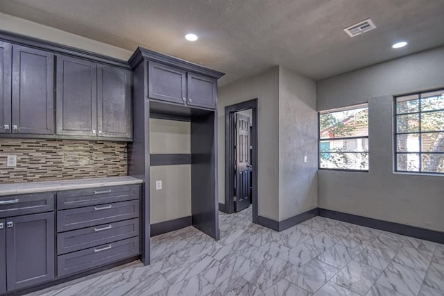 kitchen featuring gray cabinets and decorative backsplash