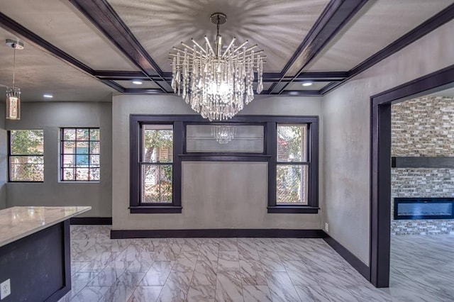 interior space with beamed ceiling, a notable chandelier, crown molding, and a fireplace