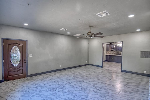 foyer entrance with ceiling fan