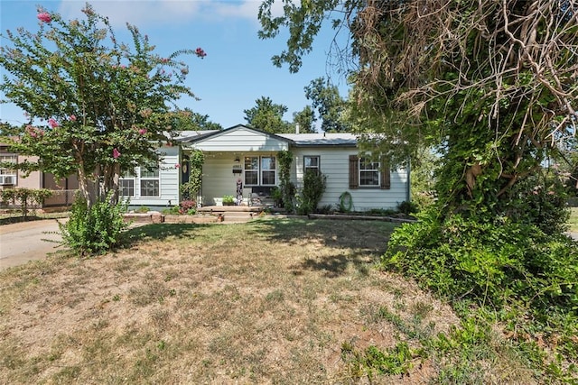 single story home with a porch and a front lawn