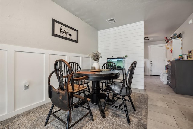 dining area featuring tile patterned flooring and ceiling fan