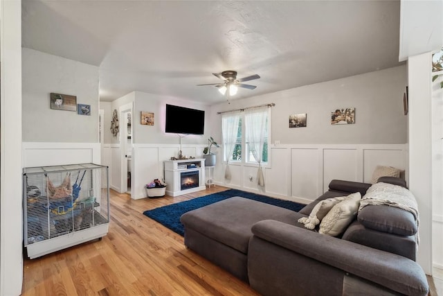 living room featuring ceiling fan and light wood-type flooring