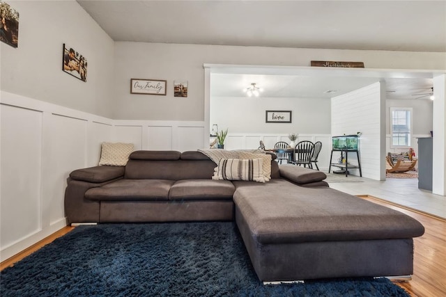 living room featuring ceiling fan and hardwood / wood-style floors