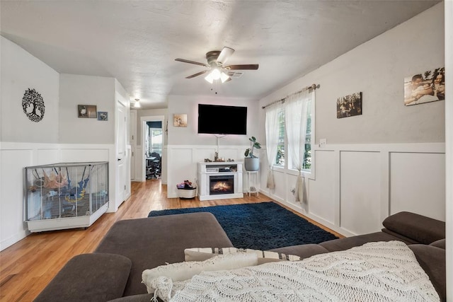 living room with ceiling fan and light hardwood / wood-style flooring