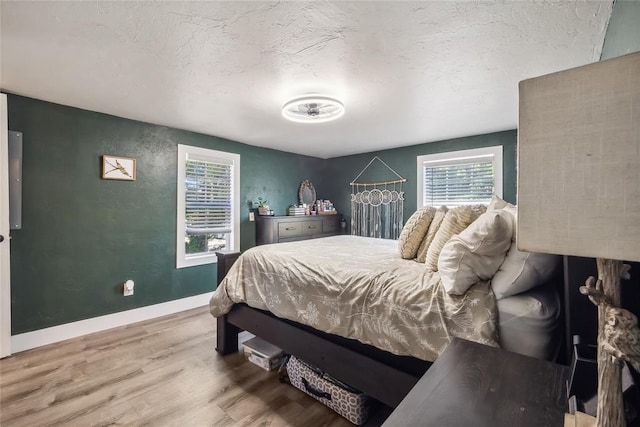 bedroom featuring hardwood / wood-style flooring and a textured ceiling