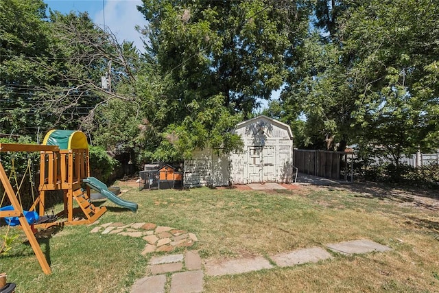 view of yard with a playground and a storage shed