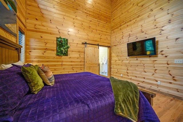 bedroom featuring wood-type flooring and wood walls