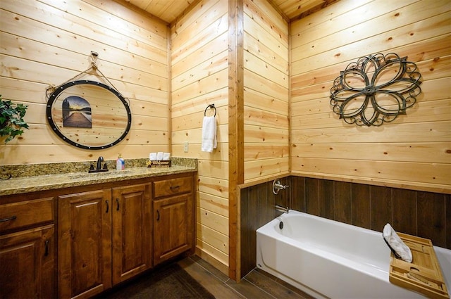 bathroom with vanity, wooden ceiling, a bathtub, and wooden walls