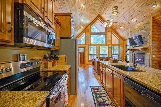 kitchen featuring wooden ceiling, sink, light stone countertops, appliances with stainless steel finishes, and light hardwood / wood-style floors