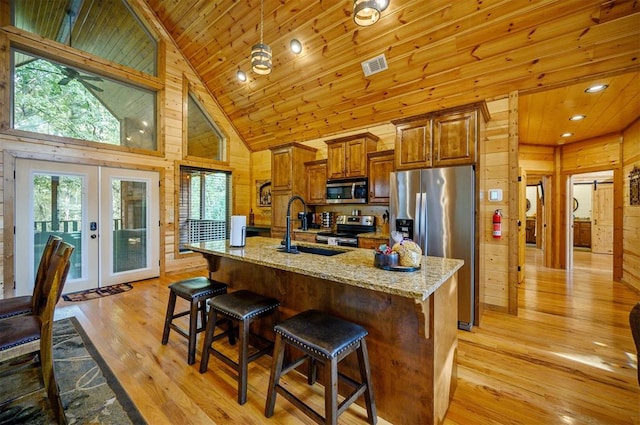 kitchen featuring french doors, stainless steel appliances, sink, high vaulted ceiling, and light hardwood / wood-style floors