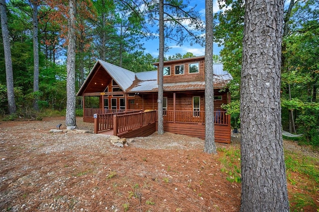 back of property featuring covered porch