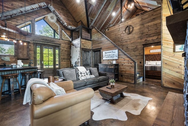 living room featuring french doors, wooden ceiling, high vaulted ceiling, and wooden walls