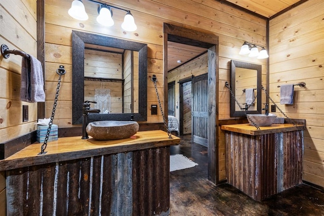 bathroom featuring vanity and wood walls