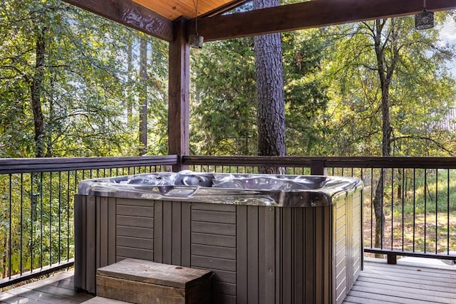 wooden deck featuring a hot tub