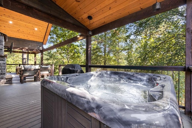 wooden deck with a grill and a hot tub