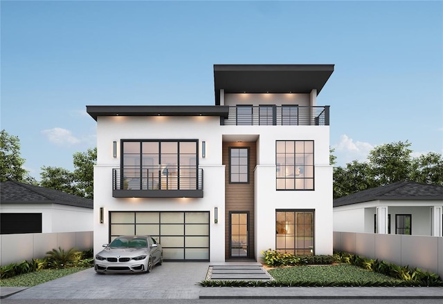 contemporary home featuring a garage and a balcony